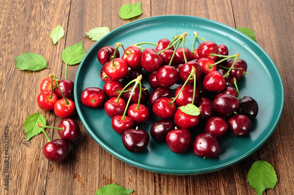 Fresh cherry fruit and leaf on wooden table. Fresh cherry fruit and leaf on wooden table.