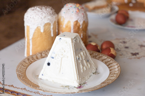 Orthodox Easter. Easter cakes, Easter Ortodox curd cake and colored eggs on table. Side view
