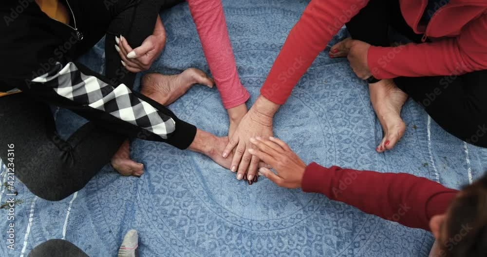 Multiracial people stacking hands - Concept of multi generational women and unity