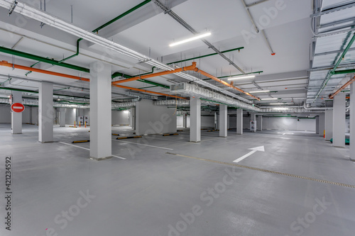 empty underground garage parking with columns and road markings