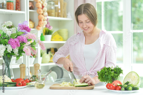 teen girl preparing fresh salad