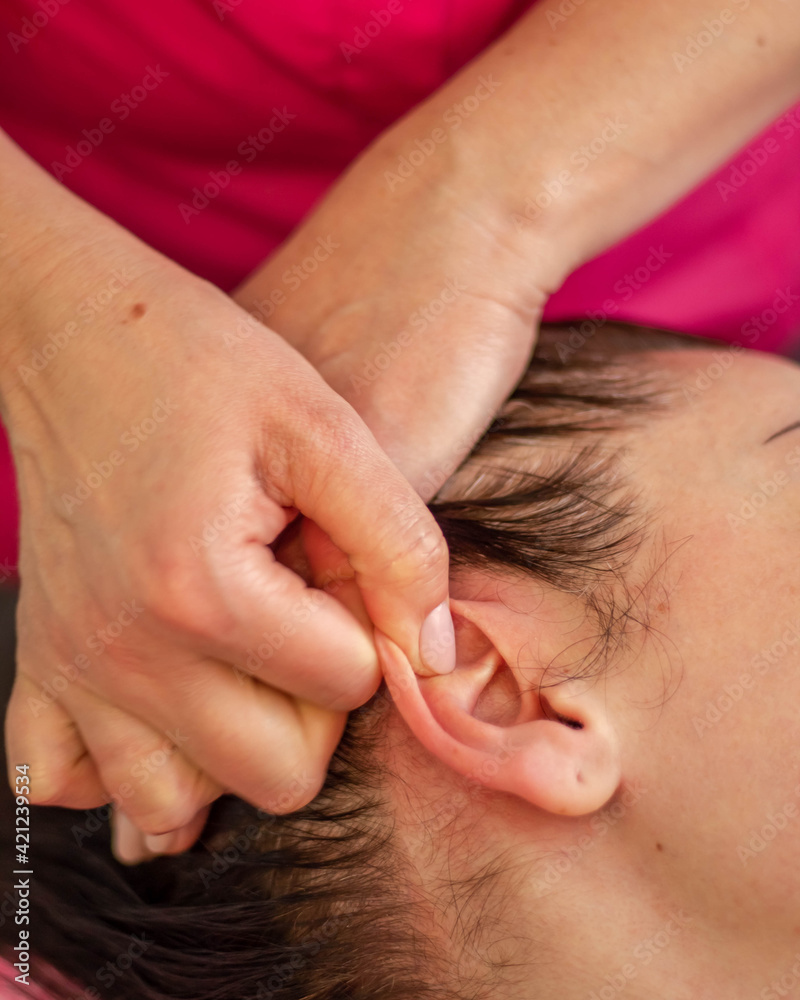 woman on ear massage in salon