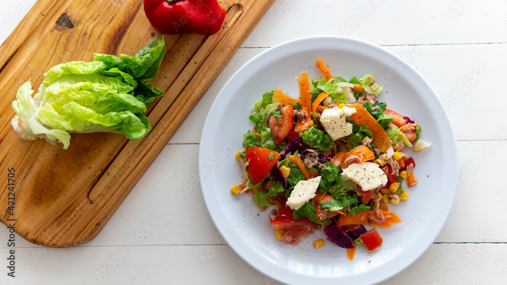 flat lay of a fresh tasty salad on top of a white table flat lay of a fresh tasty salad on top of a white table