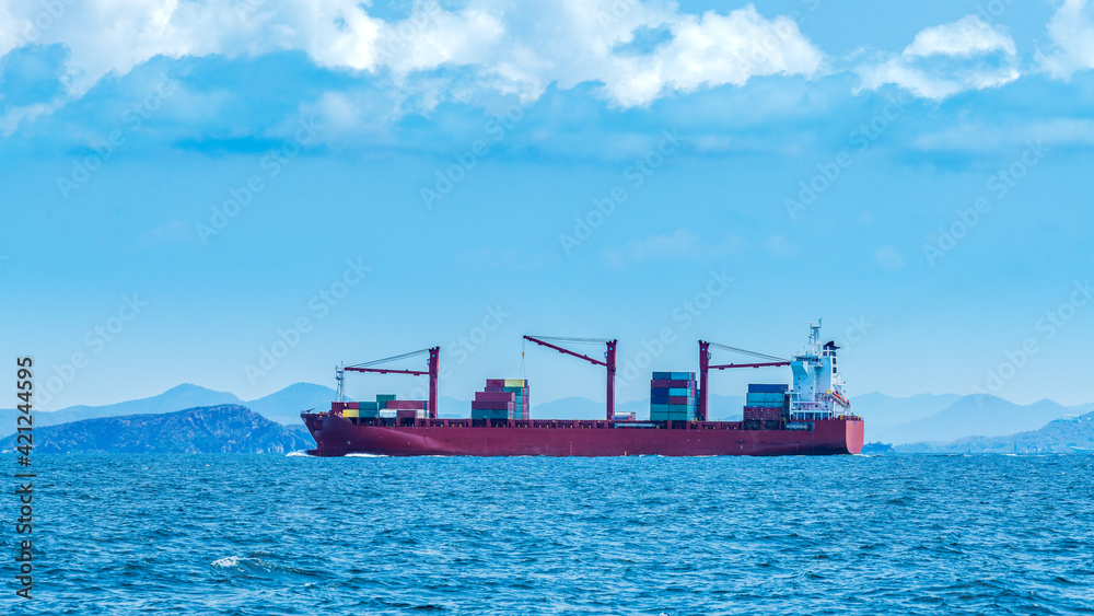 Cargo shipping transportation logistic commerce industry loading export on sea with blue cloud sky background.