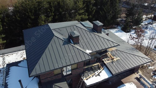 Aerial top view of new modern residential house cottage water heat system on roof. Renewable ecological green energy production concept.