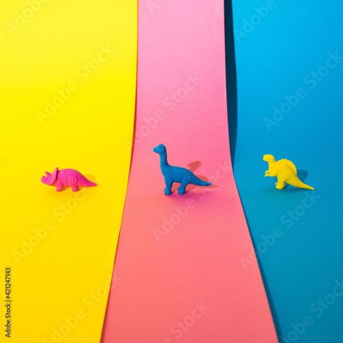 Dinosaur toys on a colorful background. Minimal creative concept. photo