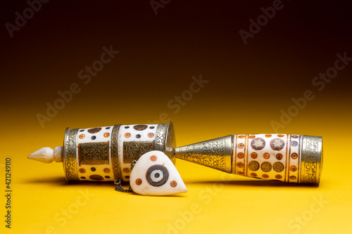 
Editorial
Handhold small buddhist prayer wheel mill. Studio religious tourist souvenir still life against a seamless yellow surface and dark background. photo