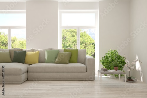 Minimalist living room in white color with sofa and summer landscape in window. Scandinavian interior design. 3D illustration