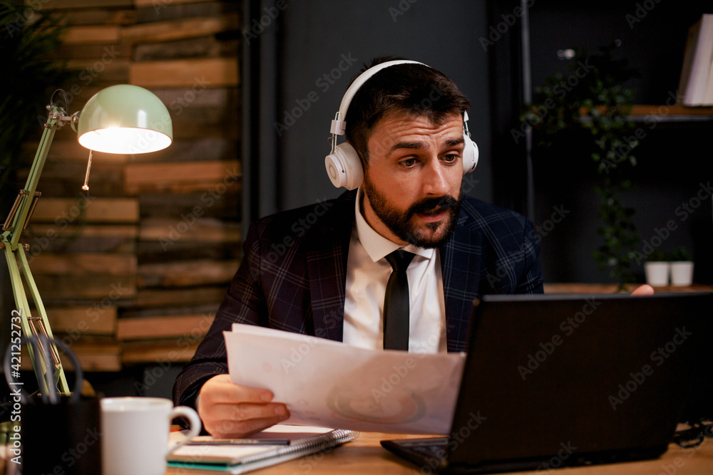 Young businessman working on laptop in his office. Handsome man having video call. Young businessman working on laptop in his office. Handsome man having video call.