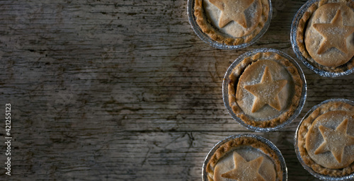 Flat Lay Photo of Some British Mince Pies on a Wooden Textured Background With Copy Space