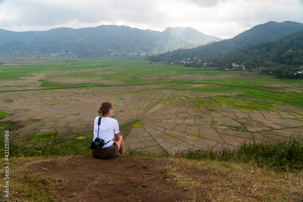 Young hiker in the spider rice field terraces in Flores Indonesia 