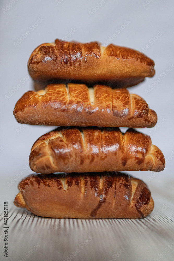 Appetizing fresh homemade buns on a wooden background, close-up.