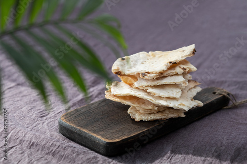 Homemade matzo with microgreen peas. Unleavened flatbread bread. Pesah celebration concept. Jewish Passover background. Pita.