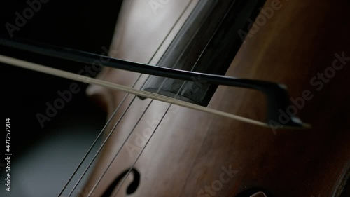 The cellist performs on stage.