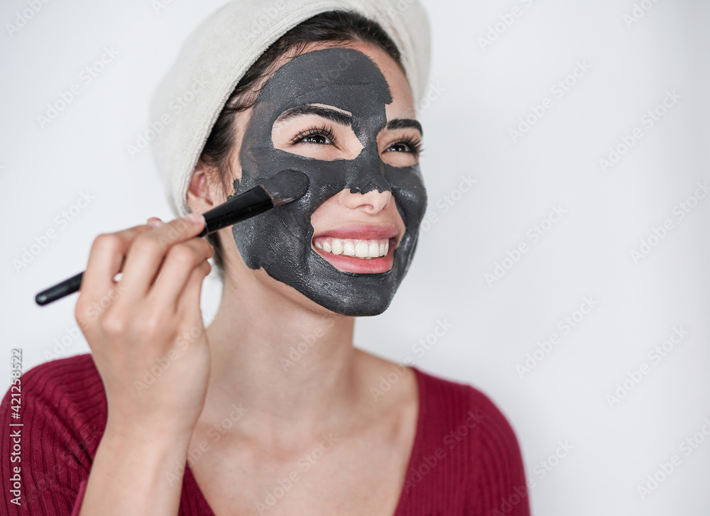 Young influencer woman streaming live video online using skin cream mask - Technology and skin care concept Young influencer woman streaming live video online using skin cream mask - Technology and skin care concept