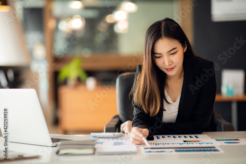 Portrait of Asian young female working on laptop