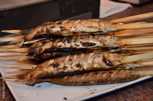 Steckerlfische - eine gegrillte Fischspezialität im Salzkammergut, Österreich, Europa - Stick fish - a grilled fish specialty in the Salzkammergut, Austria, Europe photo