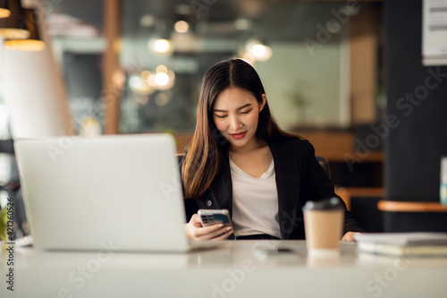 Portrait of Asian young female working on laptop at office