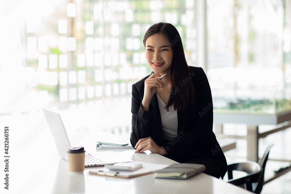 Portrait of Asian young female working on laptop at office