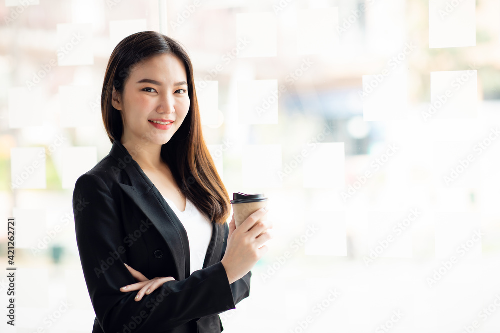 Portrait of Asian young female working on laptop at office
