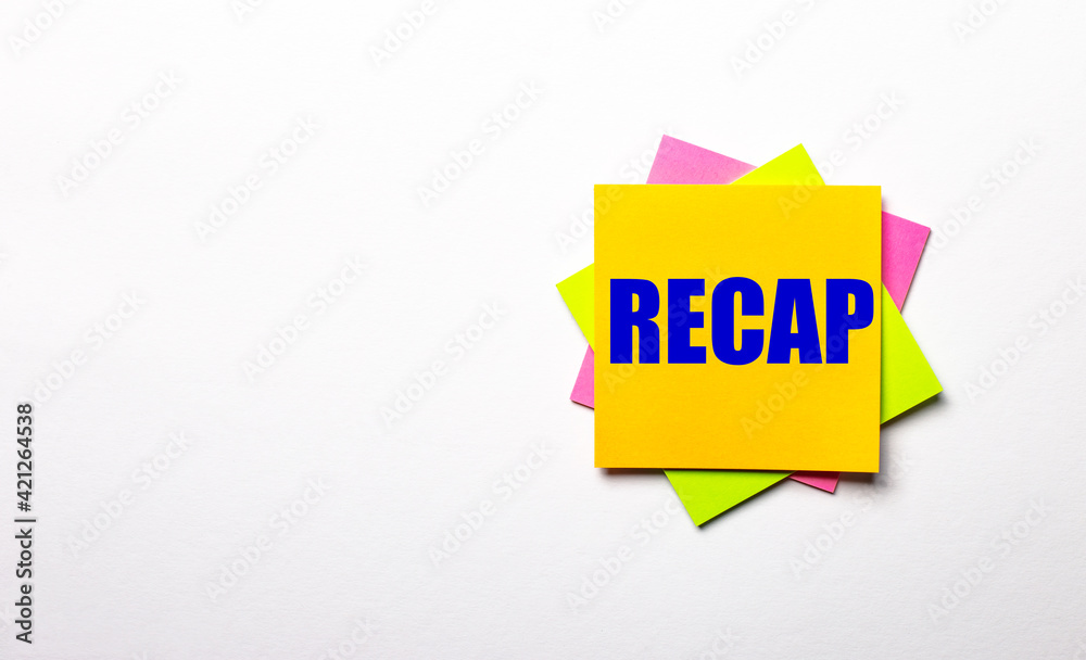 On a light background - bright multicolored stickers with the text