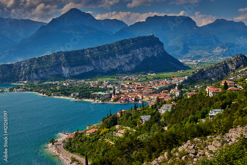 Panoramic view on Lake Garda from the Busatte-Tempesta trail near Nago-Torbole with the iron staircase, Torbole town surrounded by mountains in the summer time,Italy