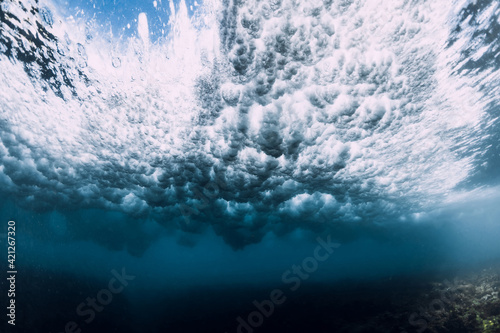 Wave underwater with foam, bubbles and sun light. Transparent ocean in underwater © artifirsov