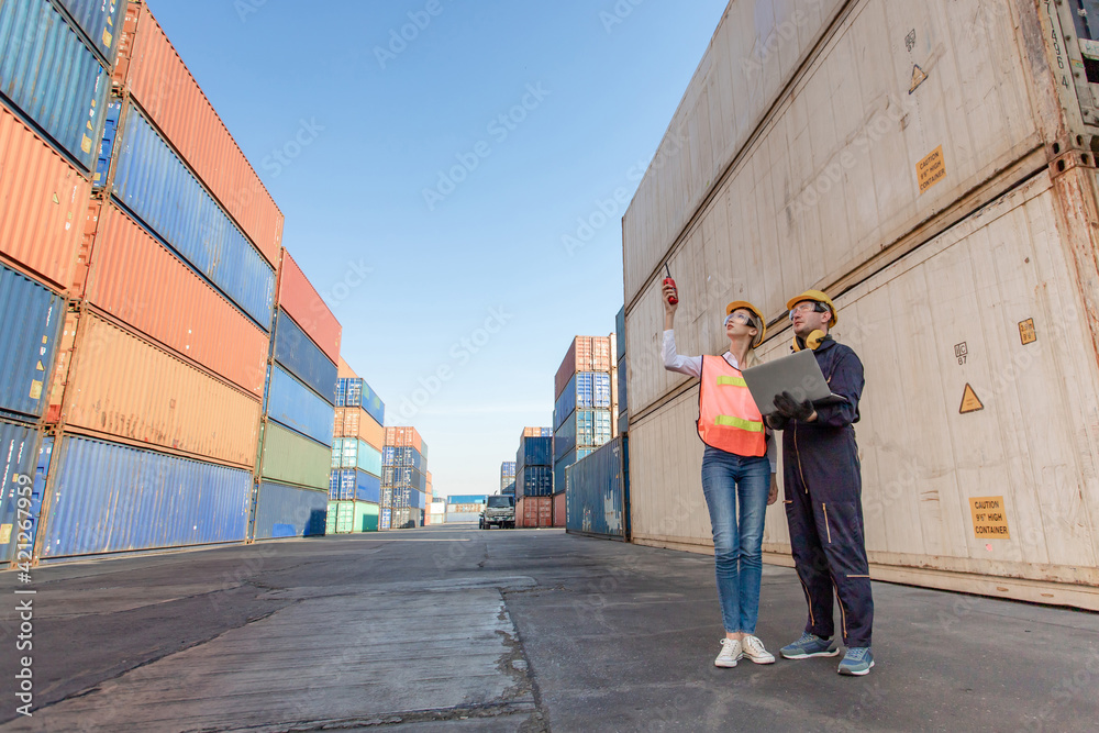 working engineer in the construction container yard. worker and supervisor checking containers data. Container Shipping Logistics Engineering concept working engineer in the construction container yard. worker and supervisor checking containers data. Container Shipping Logistics Engineering concept