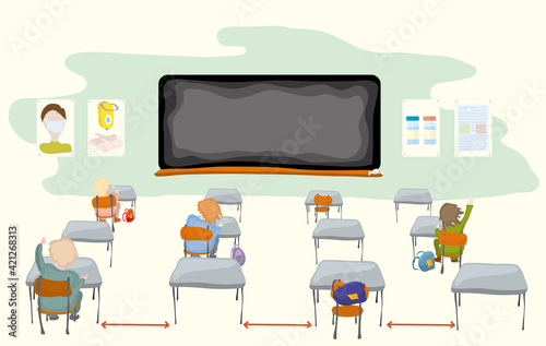 keeping distance by students during lectures, against the background of a blackboard and information stands. classroom sessions during a pandemic