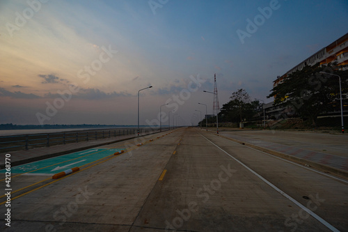 Nakhon Phanom, Thailand - February 13, 2020  Street view with beautiful sky at dawn in background © Jphoto4956