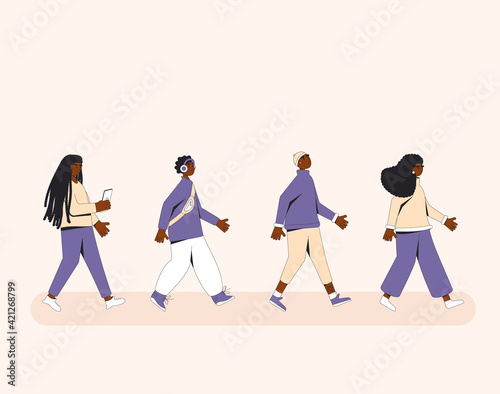 Group of african american teenagers walking one after another. Young female and male friends wearing in trendy casual clothes marching in step together. Boys and girls