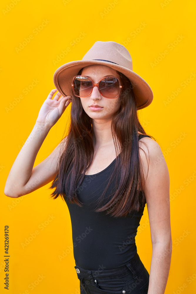 Vertical photo of a young caucasian woman on yellow background Vertical photo of a young caucasian woman on yellow background
