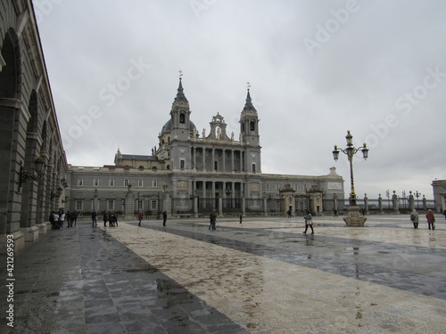 Almudena Cathedral near the Royal Palace of Madrid with tourists in Spain photo