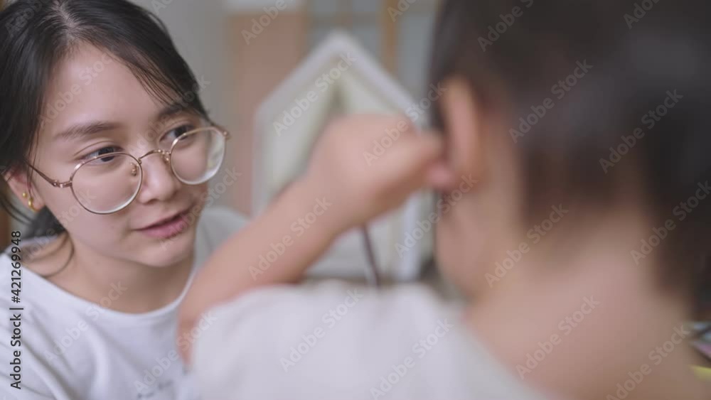 Shot of asian young mother taking care of her baby child, family spending time together at home, cute playful baby girl playing with mommy inside modern living room, young parent, warm family vibe Shot of asian young mother taking care of her baby child, family spending time together at home, cute playful baby girl playing with mommy inside modern living room, young parent, warm family vibe