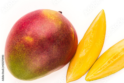 Red ripe mango fruit and slices isolated on white background. Tropical fruit mango close up studio shot