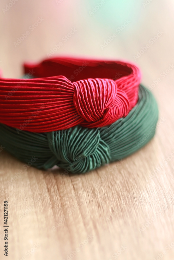 Red and green headband on wooden background. Selective focus. 