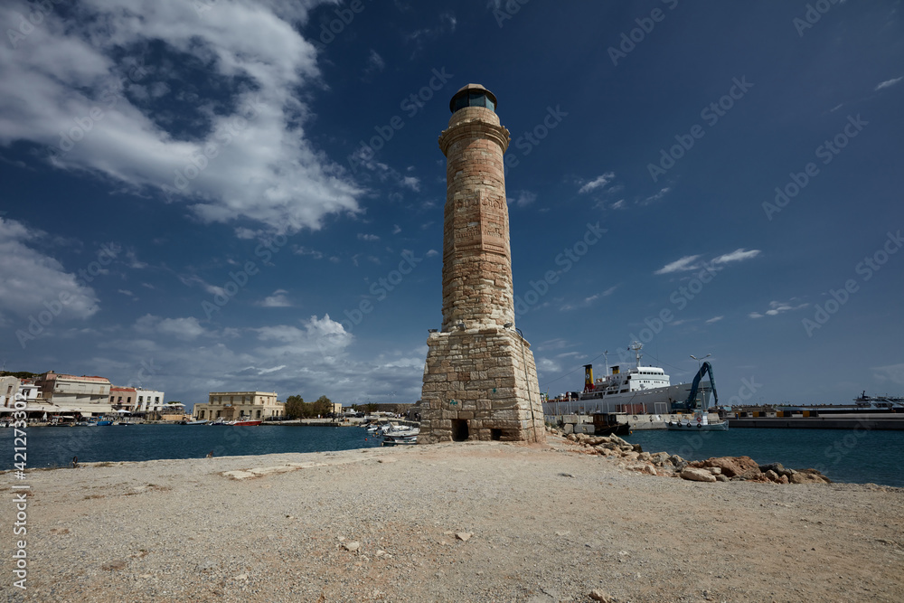 Venetian lighthouse on a background of blue sky with clouds Rethymno Crete Greece