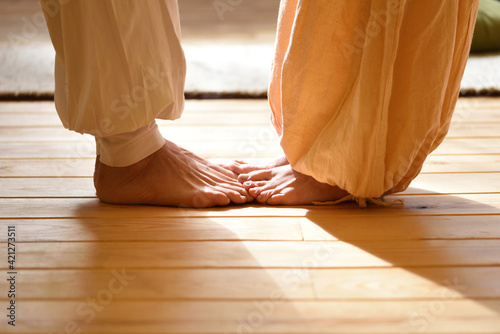 Bare feet of a man and a woman doing yoga as a couple photo
