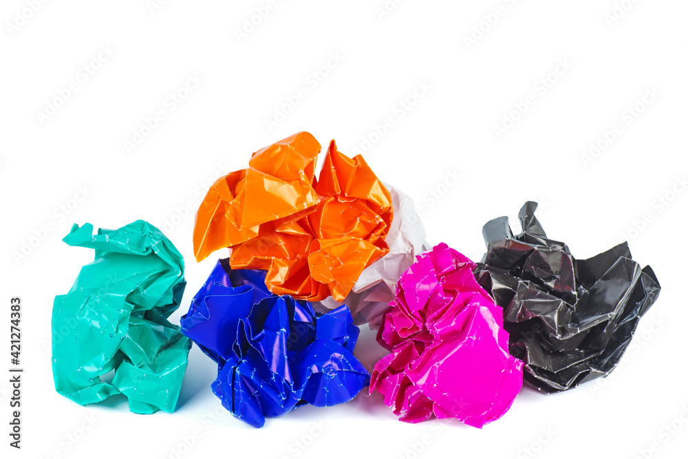 Clumps of crumpled colored paper on a white background