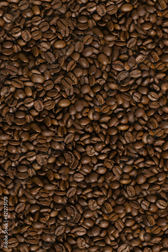 Background from coffee beans of brown color. Coffee concept. Top view.