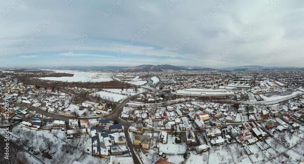 Aerial view of Mukachevo Zakarpattia, Ukraine. Roofs covered with snow, winter view of the city. Tourism and travel. widescreen panorama of large resolution