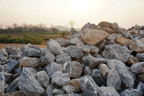 Piles of gravel limestone rocks on construction site. Break stones.