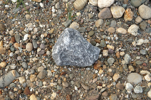 gray limestone carbonate sedimentary rock on gravel background. Used in the industry, making roads, railways, making lime, burning, cement. photo