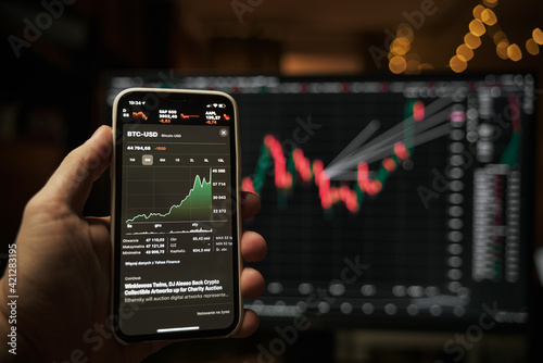 Stock market on the screen of the phone and in the background. Stock analysis and currency exchange.