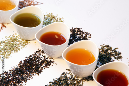 Selection of different types of loose tea brewed in small cups
