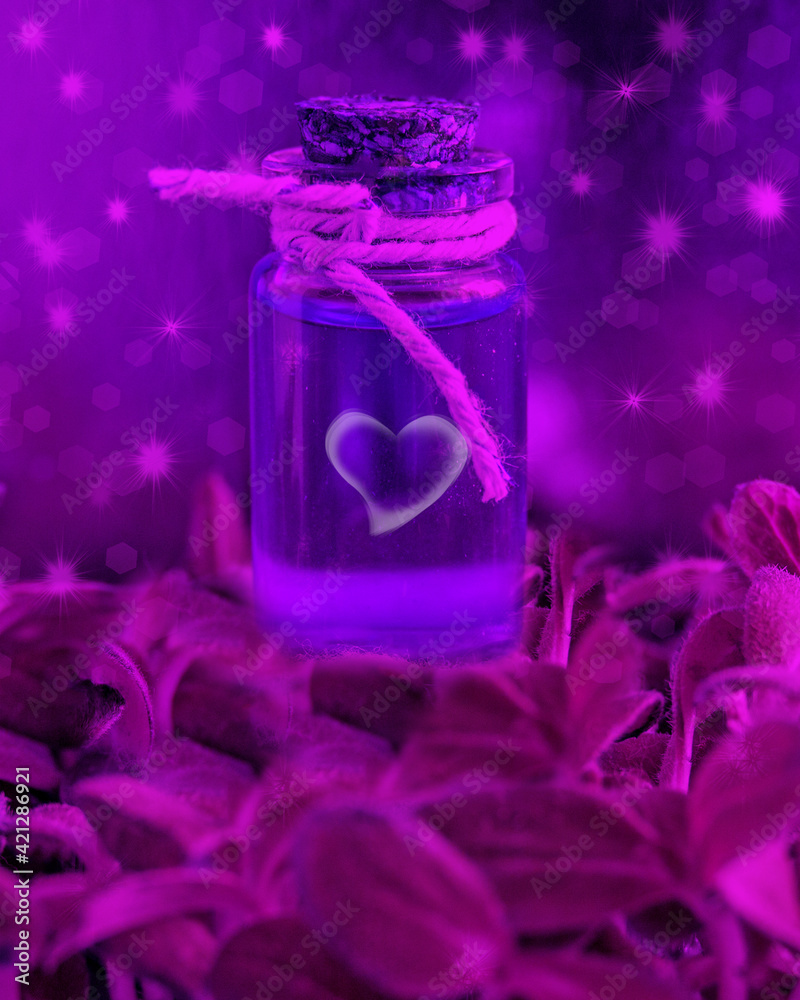 Magic potion in a glass bottle with a cork on a magic background with stars, sparks and green leaves. Magic background, copy space. Magic potion in a glass bottle with a cork on a magic background with stars, sparks and green leaves. Magic background, copy space.