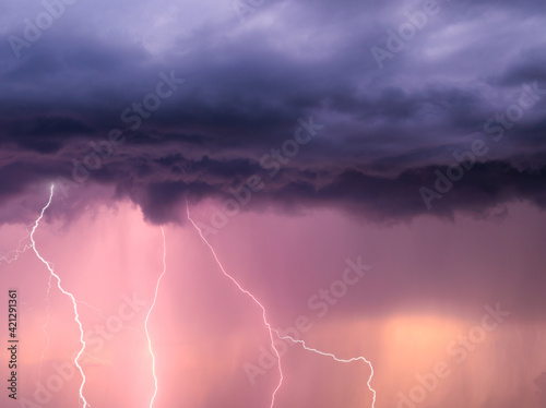 thunderstorm sky with lightning during the golden hour