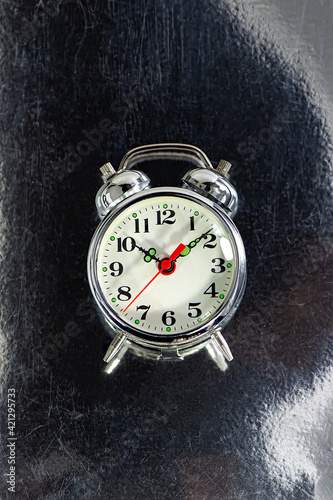 Wallpaper Mural old mechanical alarm clock lies on a scratched metal surface. Torontodigital.ca