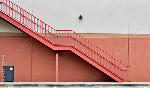 Fototapeta Naklejka Na Ścianę i Meble -  Pink stairs fire escape architecture on building street, white two tone colorful minimal descending ascending concept.