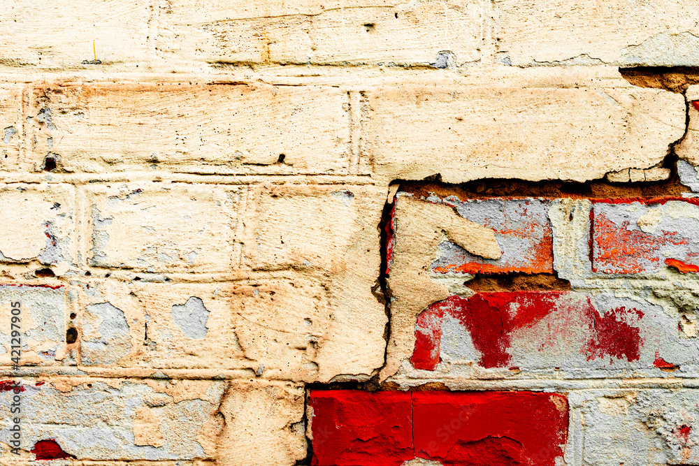 Texture of a brick wall with cracks and scratches which can be used as a background Texture of a brick wall with cracks and scratches which can be used as a background